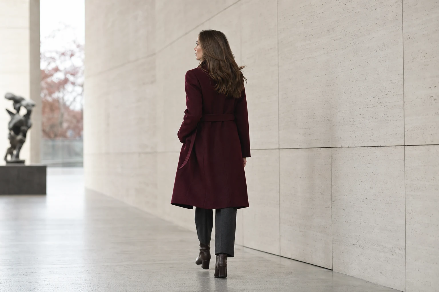 A burgundy coat balanced with cream knitwear, charcoal trousers and dark brown boots
